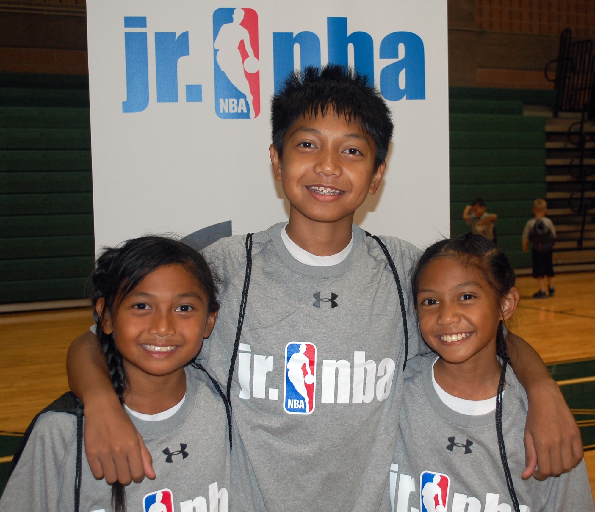 The children of Chief Petty Officer Ferdinand Ajel, of the Navy Recruiting District, San Antonio, said they had a great time and enjoyed learning more about playing defense during the Jr. NBA clinic. From left, they are Noelani, 10; Alex, 13; and Kalea, 11. (U.S. Air Force photo/Carole Chiles Fuller/Released)