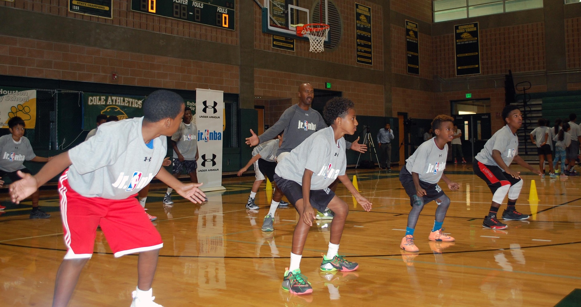 NBA Legend and former San Antonio Spurs forward Bruce Bowen joins a skills session during the Jr. NBA clinic on Oct. 19. The eight-time NBA All Defensive player helped the military youth work on defense and offense. “It’s a pleasure and an honor to be able to have an impact on some of the kids of our military servicemen and women,” said Bowen during a courtside interview. (U.S. Air Force photo/Carole Chiles Fuller/Released)