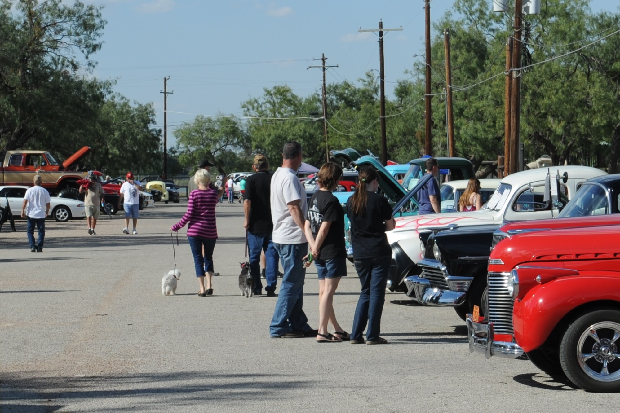 Spectators check out the vehicles during the 17th Annual Goodfellow Air Force Base Recreation Camp Car, Boat and Motorcycle Show, San Angelo, Texas, Oct. 17, 2015. Individuals entered more than 100 vehicles into the show. (U.S. Air Force photo by Staff Sgt. Laura R. McFarlane/Released)