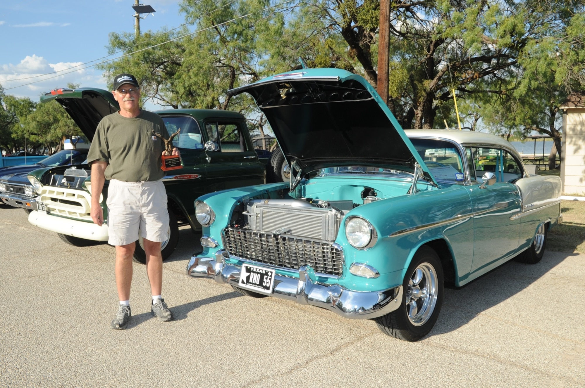 Roger M. Quincy, poses with the commander’s choice award he received for his 1955 Chevrolet Bel Air 2 door hardtop during the 17th Annual Goodfellow Air Force Base Recreation Camp Car, Boat and Motorcycle Show, San Angelo, Texas, Oct. 17, 2015. Quincy also won awards for 1950 to 1959 modified classes for both his Bel Air and his 1957 Chevrolet 3200 long bed pickup. (U.S. Air Force photo by Staff Sgt. Laura R. McFarlane/Released)