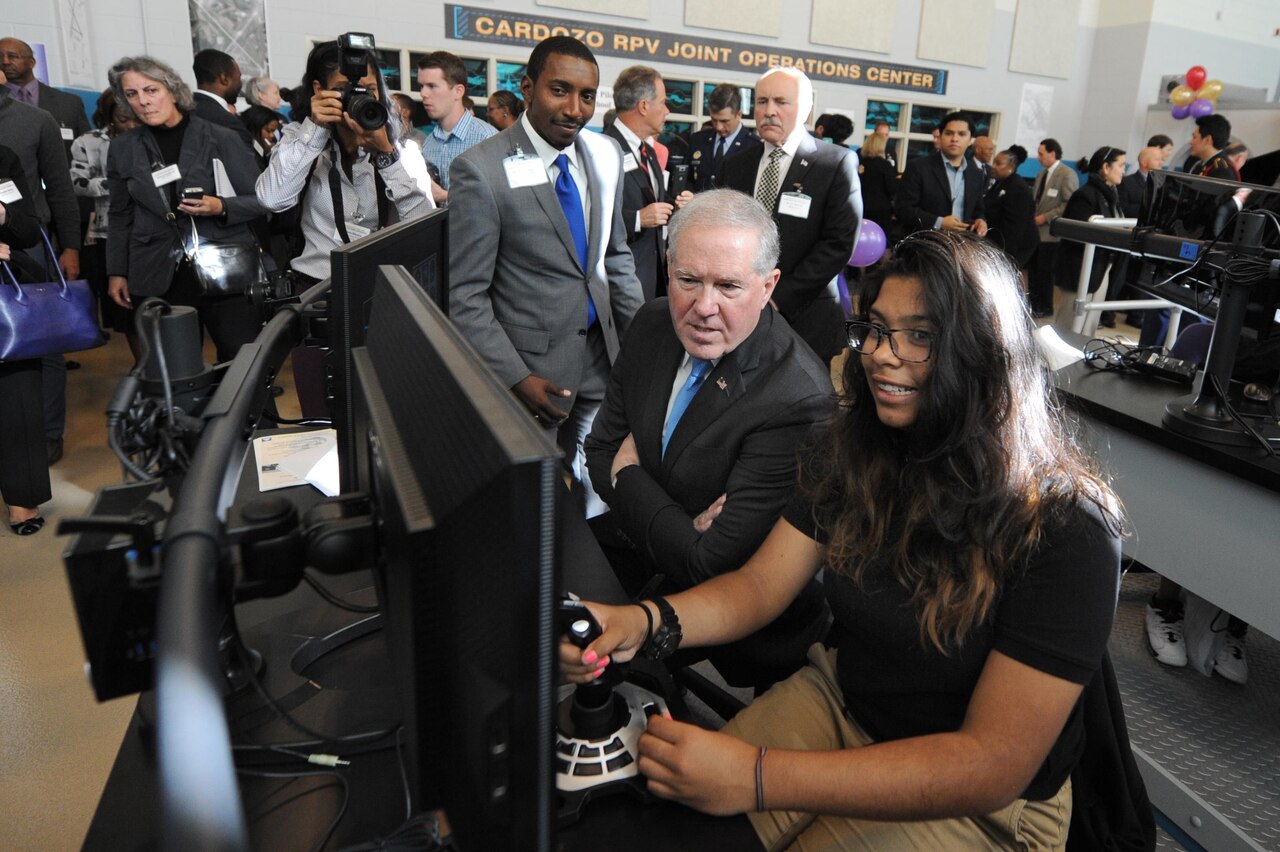 Frank Kendall, undersecretary of defense for acquisition, technology and logistics, watches a student perform simulated remote pilot operations during demonstrations at the Flexible Aviation Classroom Experience lab at Francis L. Cardozo Education Campus in Washington, D.C., Oct. 20, 2015. DoD photo by Marvin Lynchard