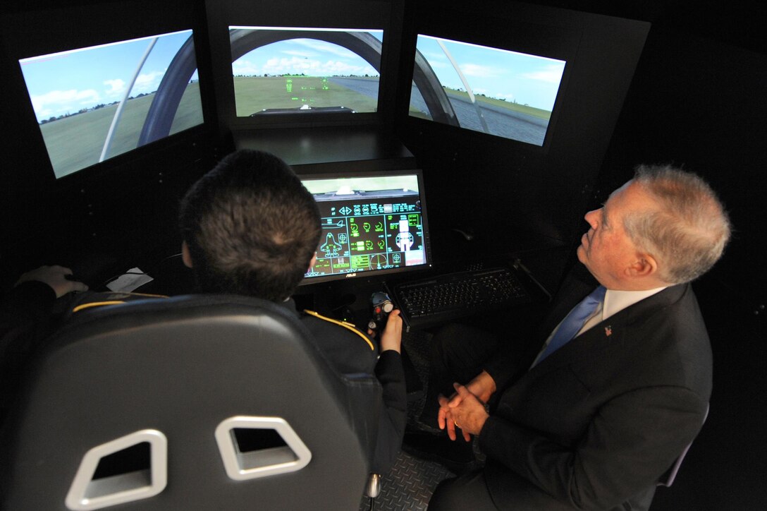 Frank Kendall, undersecretary of defense for acquisition, technology and logistics, watches a student fly a simulator during demonstrations at the Flexible Aviation Classroom Experience, or FLEX-ACE, lab at Francis L. Cardozo Education Campus in Washington, D.C., Oct. 20, 2015. DoD photo by Marvin Lynchard