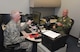 Tech. Sgt. James “Butch” Blackwell (left), 507th Force Support Squadron, issues the first common access card to 507th Air Refueling Wing commander, Col. Brian “B.S.” Davis at the new Military Personnel Section location in Building 1048, Room 112, Oct. 20, 2015 at Tinker Air Force Base, Okla. (U.S. Air Force photo/Maj. Jon Quinlan) 