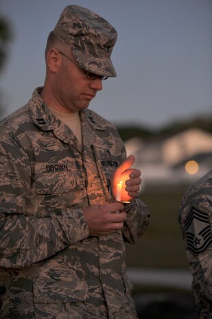 Chaplain Jesse Brown bows his head during a moment of silence remembering all of those who have been affected by domestic violence during a ceremony at Joint Base Charleston, S.C., Oct. 19, 2015. The ceremony included the reading of eight service member's stories who lost their lives in acts of domestic violence. (U.S. Air Force photo/Tech. Sgt. Renae Pittman)
