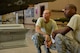 Senior Airman Andre Taylor, 756th Aircraft Maintenance Squadron lead crew member, and Senior Airman William Harris Jr., 61st Aircraft Maintenance Unit weapons load crew member, listen to an instructor in the training hangar during Luke Air Force Base’s first-ever F-35 Lightning II weapons load training on Aug. 28. The load training is designed to teach and enhance knowledge of preparation, operation, and safety to weapons load crew and maintenance members who will load munitions on the advanced F-35 platform in the future. (U.S. Air Force photo by Airman 1st Class Ridge Shan)