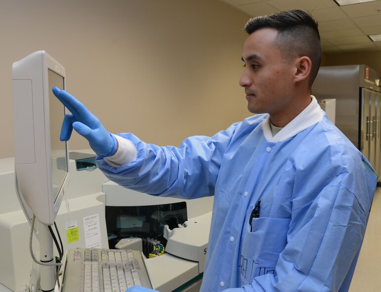 Senior Airman Tim Chao, 56th Medical Support Squadron medical laboratory technician, verifies lab results on the Siemens Dimension EXL 200 Machine October 15, 2015 at the medical building at Luke Air Force Base. The Siemens Dimension EXL 200 can perform a variety of test that includes testing for diabetes, thyroid stimulating hormone and hemoglobin deficiencies. (U.S. Air Force photo by Airman 1st Class Cory Gossett)