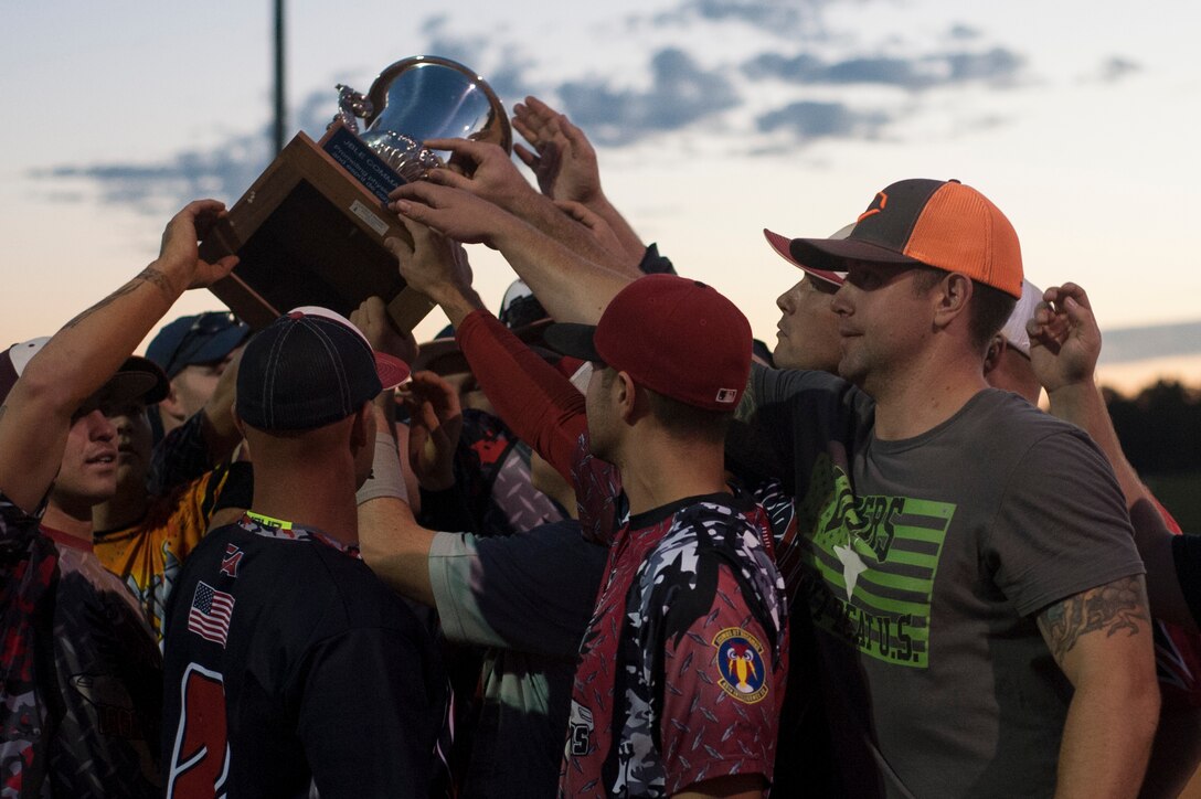 The Langley All-Star Softball team gathers following their win during the Joint Base Langley-Eustis All-Stars Softball game at Langley Air Force Base, Va., Oct. 14, 2015. The Langley All-Stars continued Langley’s winning streak which began with the first Commander’s Cup All-Stars game which concluded the intermural football season game. (U.S. Air Force photo by Senior Airman R. Alex Durbin/Released)