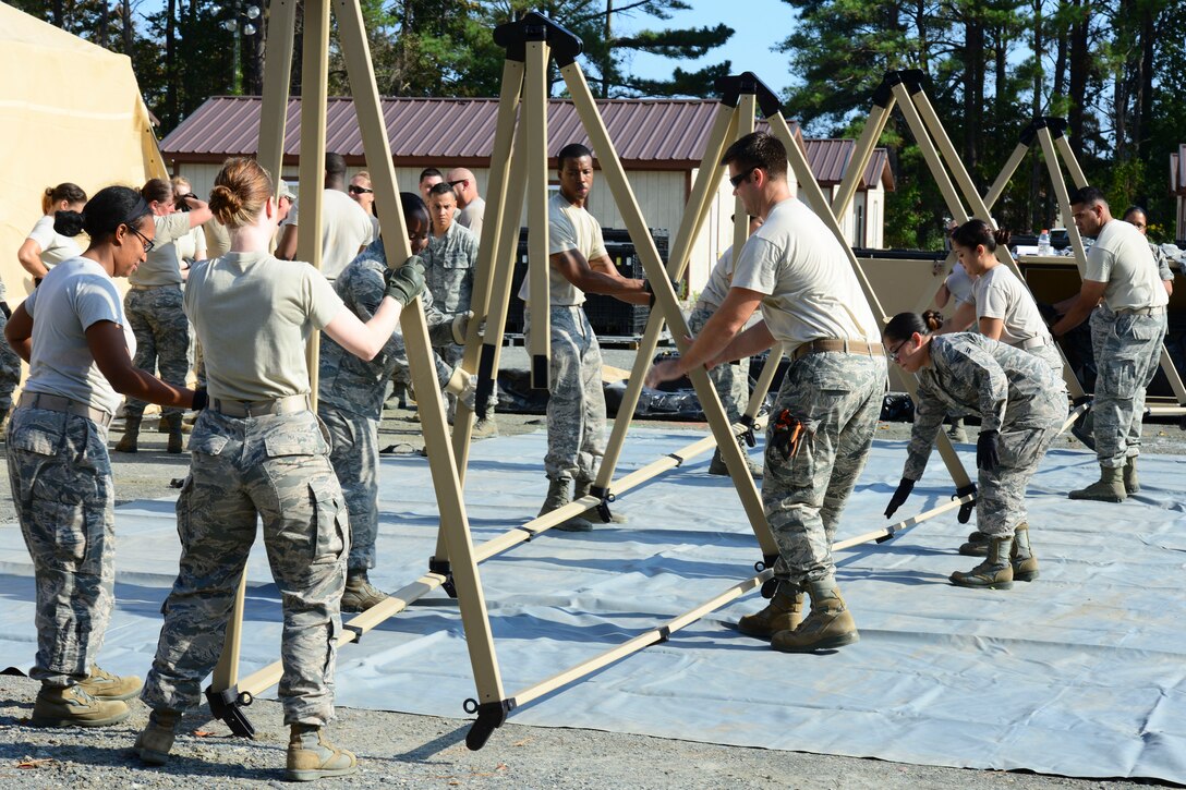 U.S. Air Force Airmen assigned to the 633rd Medical Group set up a tent for a medical training exercise at Langley Air Force Base, Va., Oct. 13, 2015. The Airmen must be proficient in building a hospital to support patients in a deployed setting to ensure timely and practical care.  (U.S. Air Force photo by Staff Sgt. Ciara Gosier/Released)