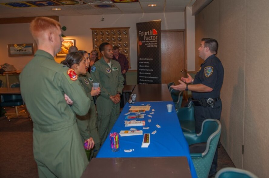 Senior Officer Aaron Moss, Minot Police Department field training officer, talks to Minot members at Minot Air Force Base, N.D., Oct. 14, 2015. Minot held a winter safety expo to help educate Minot personnel about the upcoming winter. (U.S. Air Force photo/Airman 1st Class Christian Sullivan)