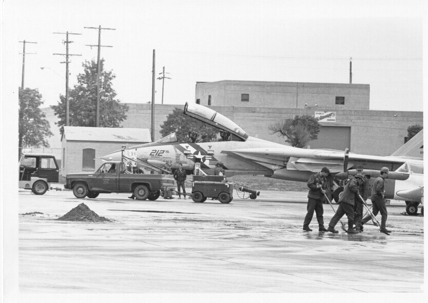 A U.S. Navy F-14 Tomcat fighter is towed outside to leave the base as crews clean up ash from the Mt. St. Helens eruption, May 21, 1980. It was here for the Open House on May 18. (U.S. Air Force photo by Airman 1st Class David Mcleod)