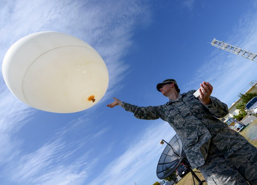 U.S. Air Force Capt. Elizabeth Ramoso, 353rd Special Operations Support Squadron commander, releases a weather balloon into the sky Oct. 19, 2015, on Kadena Air Base, Japan. The balloon is part of a Tactical Air Control Sounding Kit which is capable of gathering an assortment of atmospheric conditions from ground level to upwards of 40,000 feet. (U.S. Air Force photo by Senior Airman John Linzmeier)