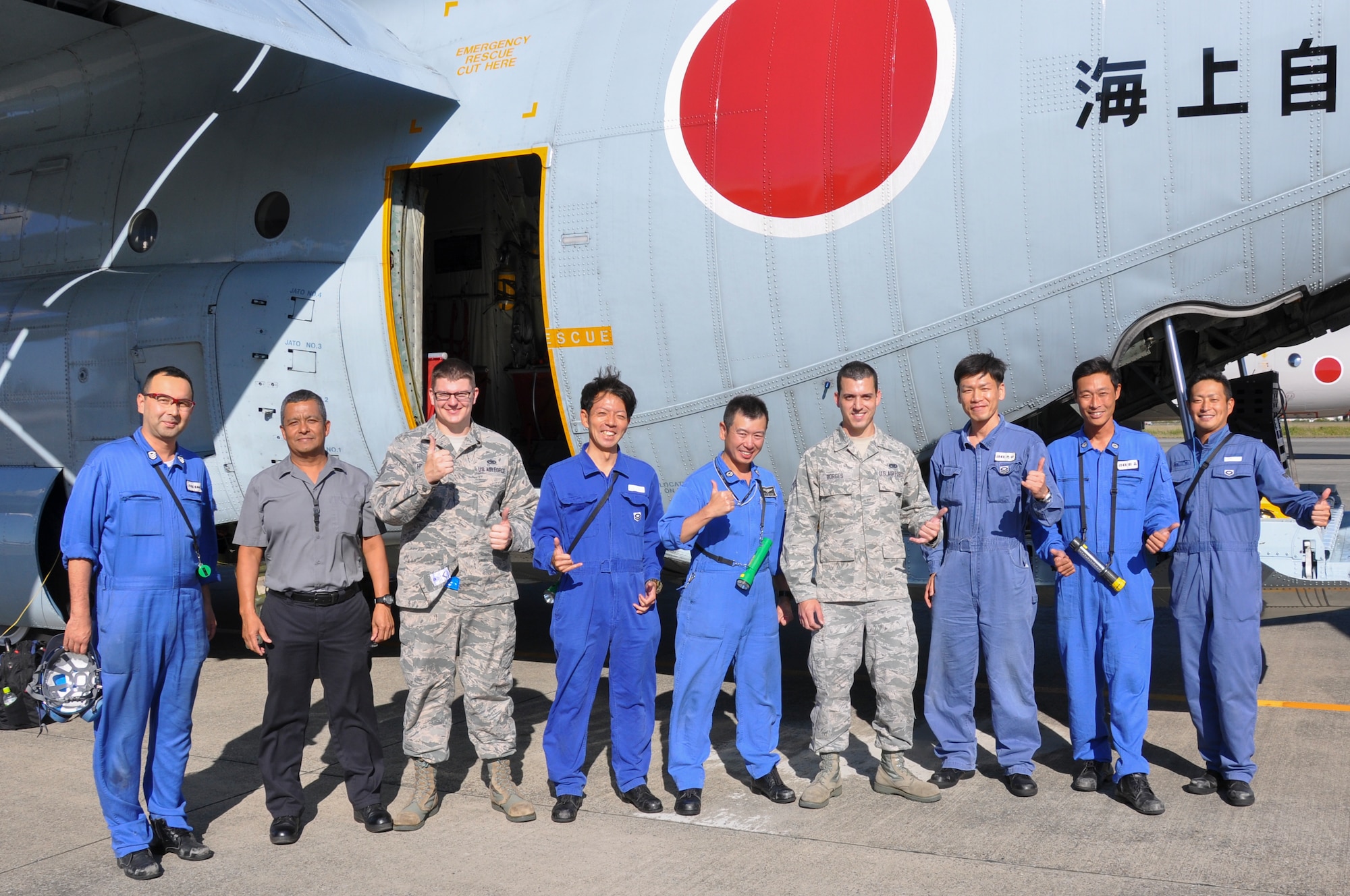 Japan Maritime Self-Defense Force and Yokota Air Base members pose for a photo at Naval Air Facility Atsugi, Japan, Oct. 8, 2015. The Yokota technicians and JMSDF personnel spent their entire day working alongside one another, improving their interoperability while providing an opportunity to learn from one another. (Courtesy photo by 374th Maintenance Group)