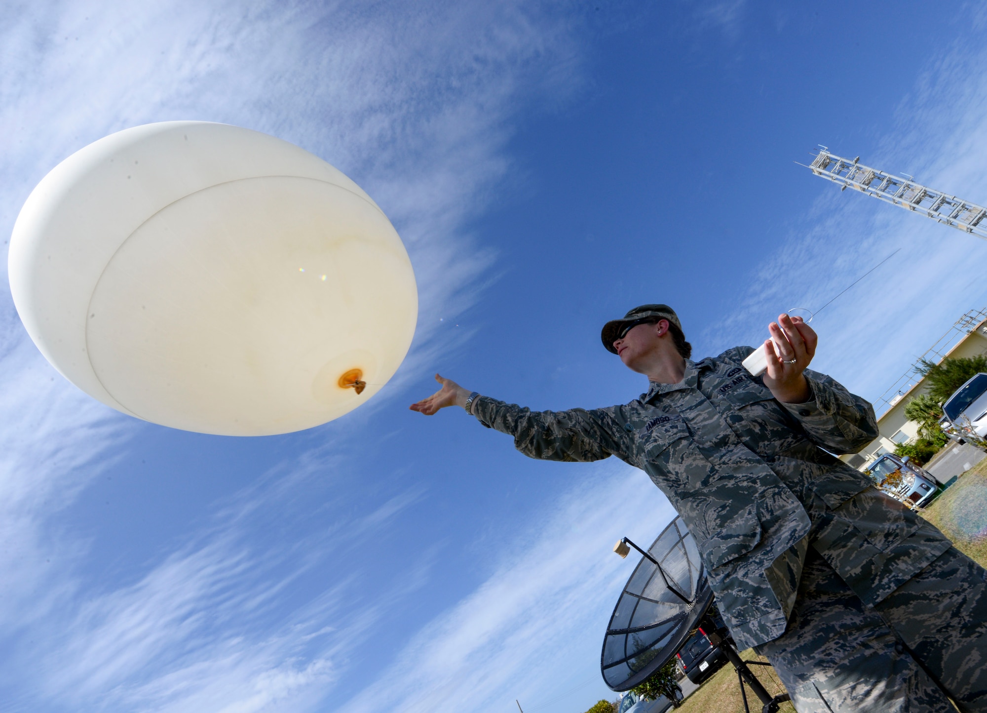 U.S. Air Force Capt. Elizabeth Ramoso, 353rd Special Operations Support Squadron Weather Flight commander, releases a weather balloon into the sky Oct. 19, 2015, on Kadena Air Base, Japan. The balloon is part of a Tactical Air Control Sounding Kit which is capable of gathering an assortment of atmospheric conditions from ground level to upwards of 40,000 feet. (U.S. Air Force photo by Senior Airman John Linzmeier)