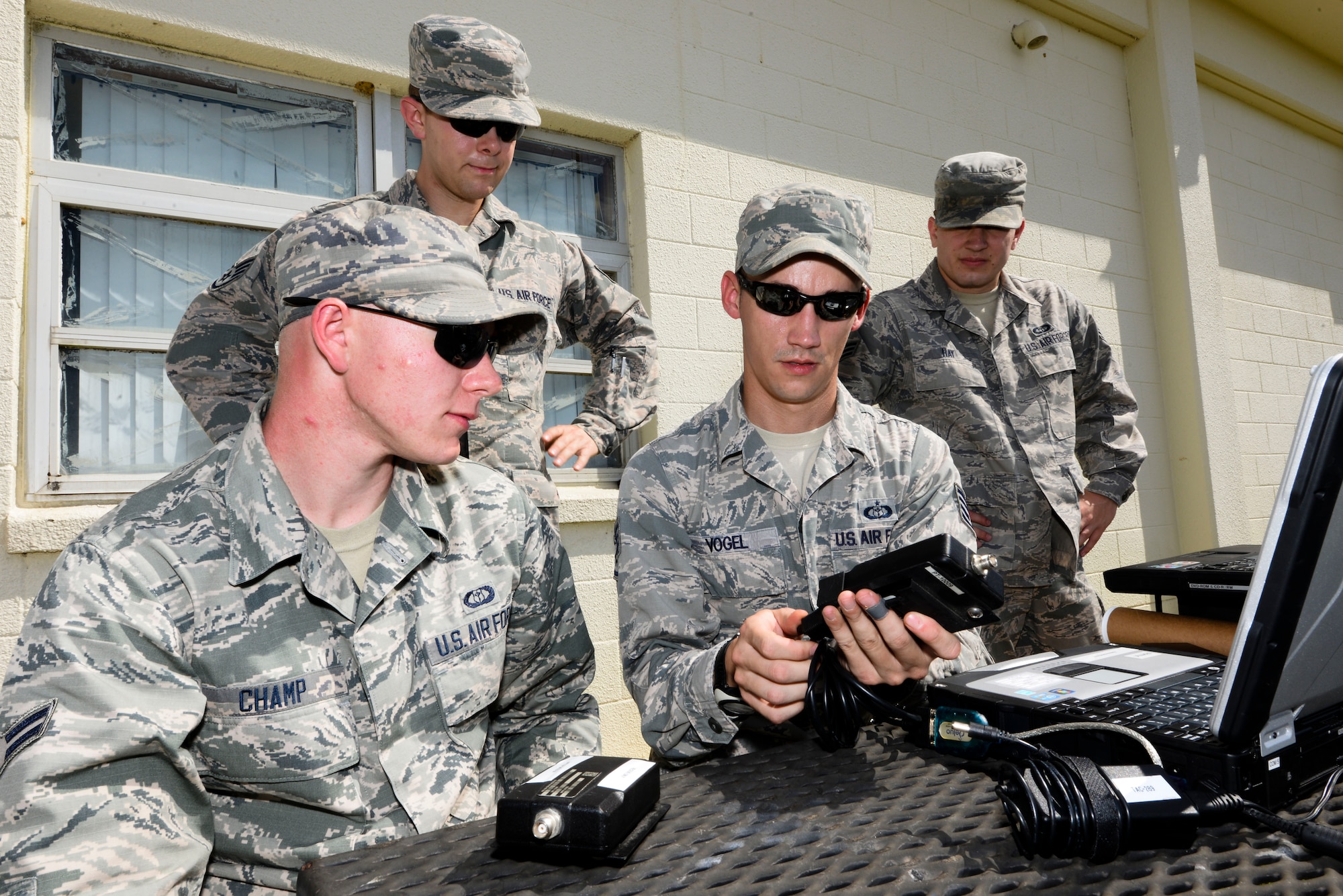 U.S. Air Force Staff Sgt. Rudi Vogel (center), 353rd Weather Flight NCO in charge of contingency weather operations and training, demonstrates how to operate a radio modem to Airmen in his flight Oct. 19, 2015, on Kadena Air Base, Japan. The flight conducts hands-on training on a monthly basis to test equipment and sharpen skillsets. (U.S. Air Force photo by Senior Airman John Linzmeier)