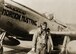 Roland R. Wright stands next to the P-51 