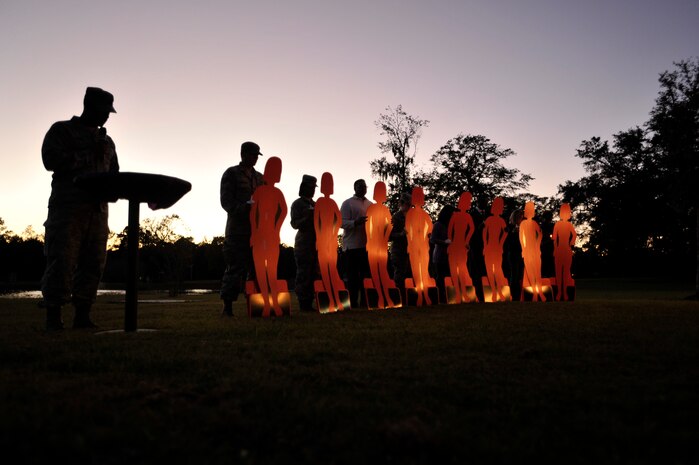 Capt. Sean Kimsey, 628th Medical Group officer, reads stories of fallen Airmen during the Domestic Violence candlelight vigil ceremony at Joint Base Charleston, S.C., Oct. 19, 2015. The ceremony honored all of those who have been affected by domestic violence, both living and deceased, by sharing stories, lighting candles and releasing balloons. (U.S. Air Force photo/Tech. Sgt. Renae Pittman)