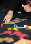 Molly Bond decorates a paper bag Oct. 15, 2015 at the Youth Center on Dover Air Force Base, Del. The bag decorating was a part of the Deployed Families Dinner which is a quarterly event for families of deployed Team Dover members. (U.S. Air Force photo/Staff Sgt. Jared Duhon)