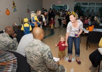 Shelley Saffran and her son, Steven, walk passed the judges of a best costume contest during the Deployed Families Dinner Oct. 15, 2015 at the Youth Center on Dover Air Force Base, Del. The contest was judged by three first sergeants. (U.S. Air Force photo/Staff Sgt. Jared Duhon) 