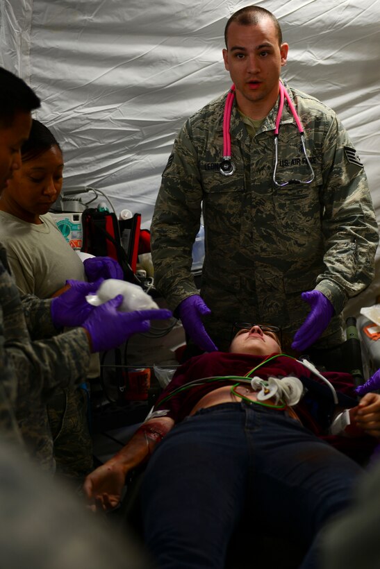 U.S. Air Force Staff Sgt. Christopher Leonard, 633rd Medical Operation Squadron   , assesses a simulated patient’s injuries during a mass casualty exercise at Langley Air Force Base, Va., Oct. 15, 2015.  Volunteers simulated injuries for medical Airmen to assess and treat during the exercise. (U.S. Air Force photo by Staff Sgt. Ciara Gosier/Released)