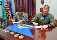Col. Michael Grismer, 436th Airlift Wing commander, and Chief Master Sgt. Keith Davis, 436th AW command chief, fill out their donation forms for the Combined Federal Campaign Oct. 19, 2015, at Dover Air Force Base, Del. Last year, Team Dover raised more than $76,000 for CFC and the goal this year is to raise $78,000.  (U.S. Air Force photo/senior Airman William Johnson )