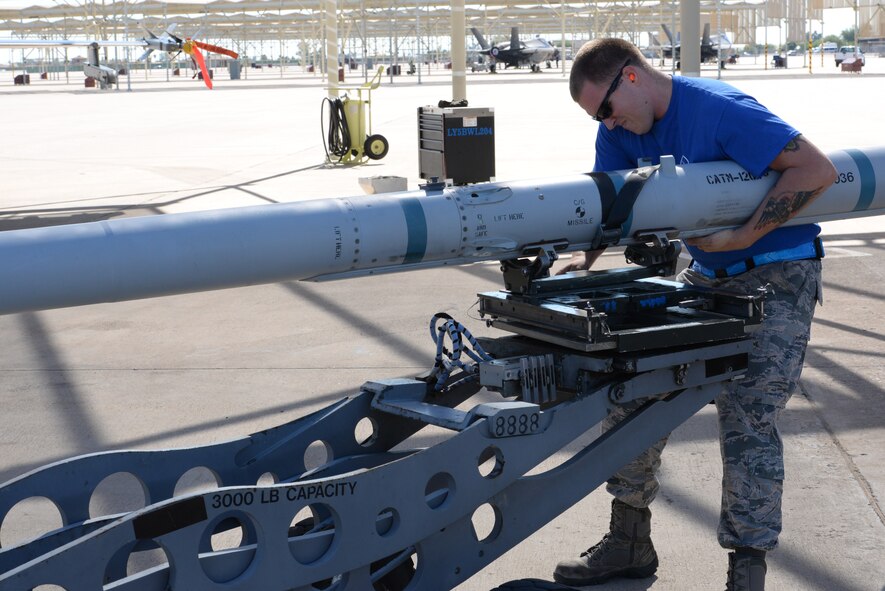 Staff Sgt. Timothy O’Brien, 309th AMU load crew member, adjusts a missile during the competition.The quarterly load crew competition challenges units to form a crew capable of excellent speed and efficiency. (U.S. Air Force photo by Airman 1st Class Ridge Shan)
