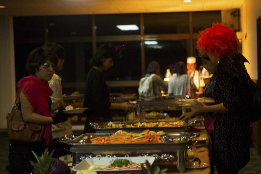 Guests enjoy a dinner  buffet at the VIP opening of the Futenma Haunted Labyrinth Oct. 9 Marine Corps Air Station Futenma, Okinawa, Japan. The Futenma Haunted Labyrinth is a fundraiser for the Single Marine Program held annually for the past four years. Approximately 200 Okinawa residents and service members came together to enjoy a good scare and a dinner buffet at the Habu Pit. The labyrinth is scheduled to open its doors to the public Oct. 23, 24, 29, and 30.