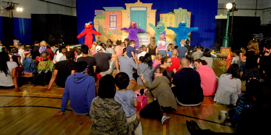 Families watch the United Service Organization Sesame Street performance on Osan Air Base, Republic of Korea, Oct. 15, 2015. The show specifically targets military families by giving children tips for coping during a move to a new base or when a parent deploys and giving parents talking points to use with their children. (U.S. Air Force photo/Senior Airman Kristin High)