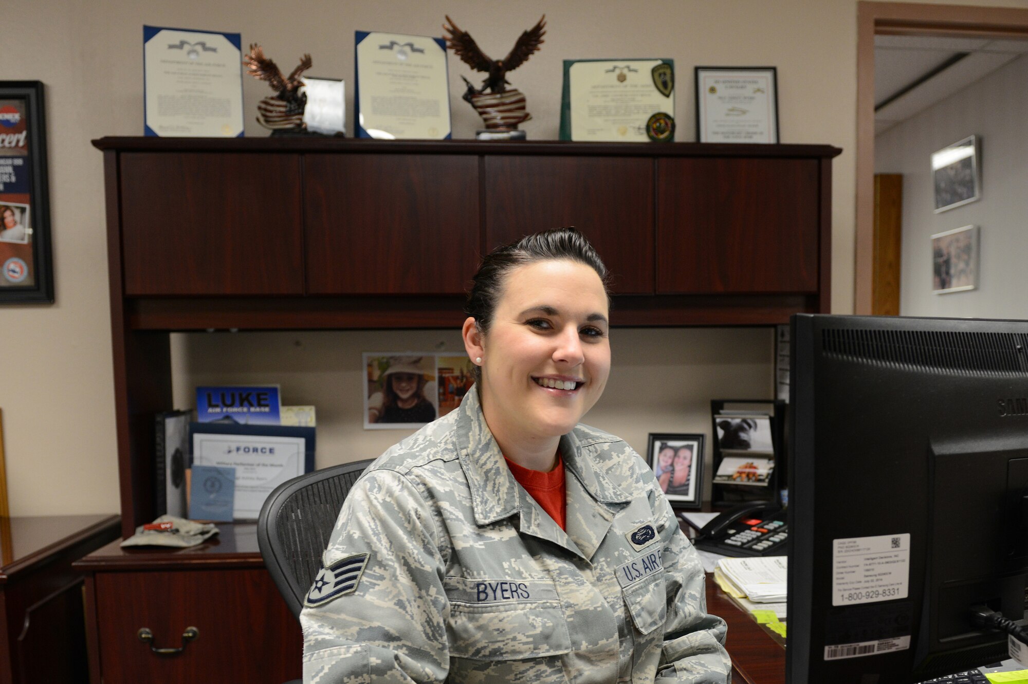 Staff Sgt. Ashley Byers, 56th Force Support Squadron NCO in charge commanders support staff, sits at her desk at Luke Air Force Base, Arizona, Oct. 16, 2015. Byers assists the 56th FSS commander in their objectives on a daily basis. (U.S. Air Force photo by Senior Airman James Hensley)