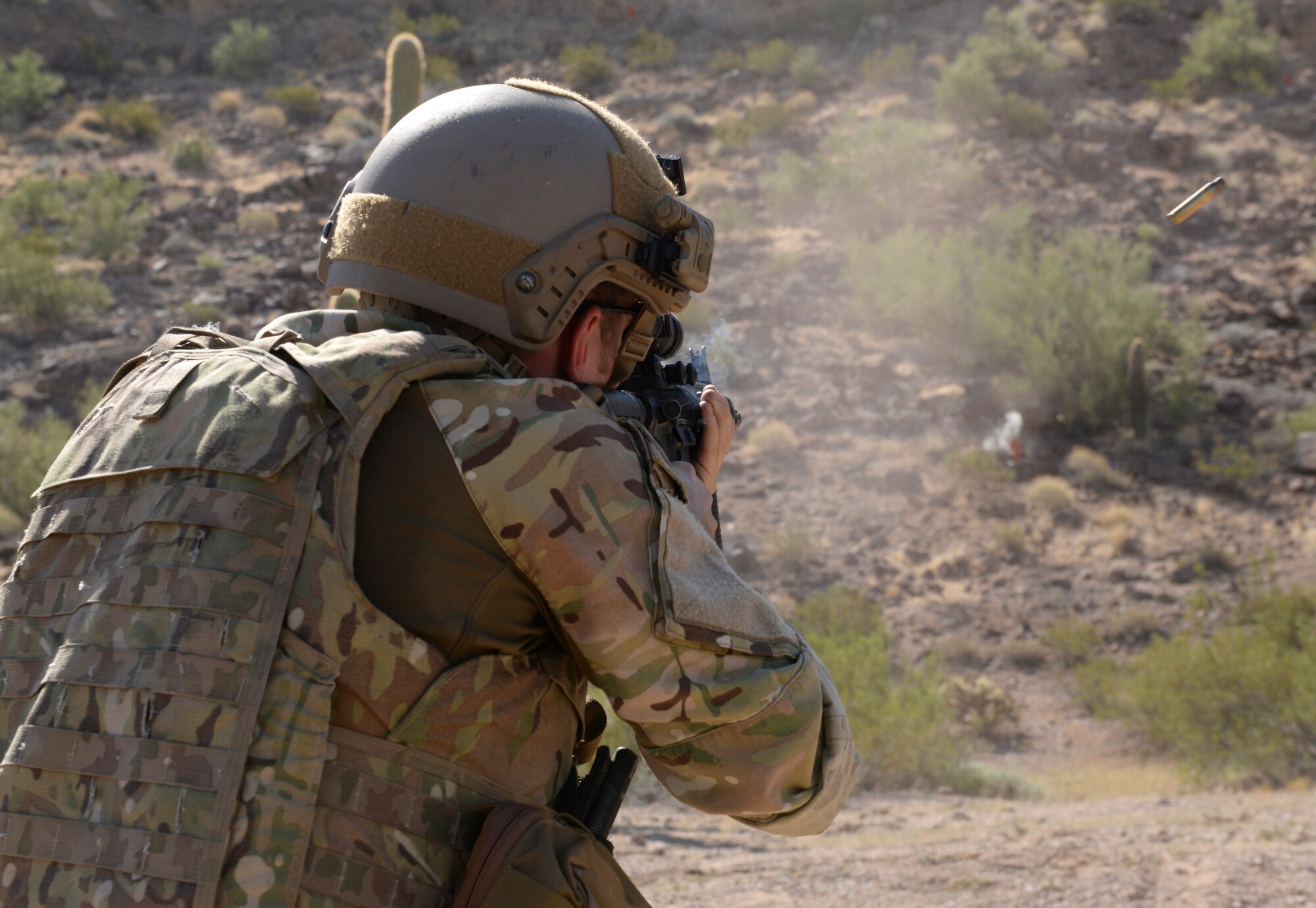 The shell is ejected (upper right side of photo) as Staff Sgt. Michael Garrison, 56th CES EOD team leader, fires an M4 at a target. (U.S. Air Force photo by Airman 1st Class Ridge Shan)