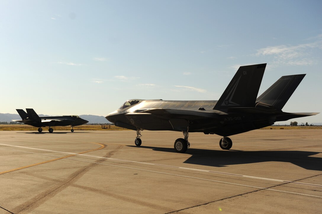 An Australian F-35 lightning ll taxies behind a Luke Air Force Base F-35, Sept. 16, 2015. The F-35 is an aircraft with an international footprint unlike any other in history. Currently, Luke has two F-35 squadrons but will eventually be home to six squadrons, all including partner nations. (U.S. Air Force photo by Staff Sgt. Staci Miller)