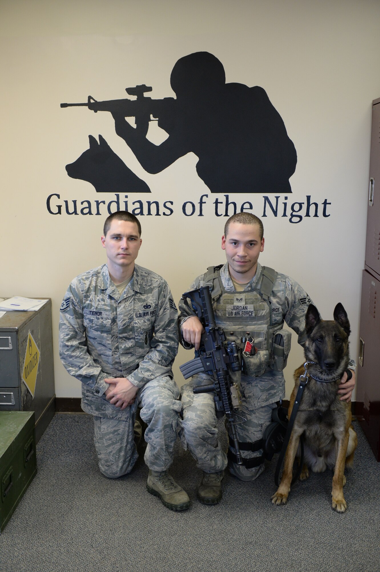 U.S. Air Force Staff Sgt. Carey Tignor, a 354th Security Forces Squadron (SFS) military working dog (MWD) trainer, takes a break from work with Senior Airman Shaun Jordan, a 354th SFS MWD handler and Zzaryn, before a training session Oct. 13, 2015, at Eielson Air Force Base, Alaska. Tignor said the accomplishment he is most proud of is when he was promoted to the position of MWD trainer because he has an opportunity to effectively multiply Eielson’s MWD force. (U.S. Air Force photo by Senior Airman Peter Reft/Released)   