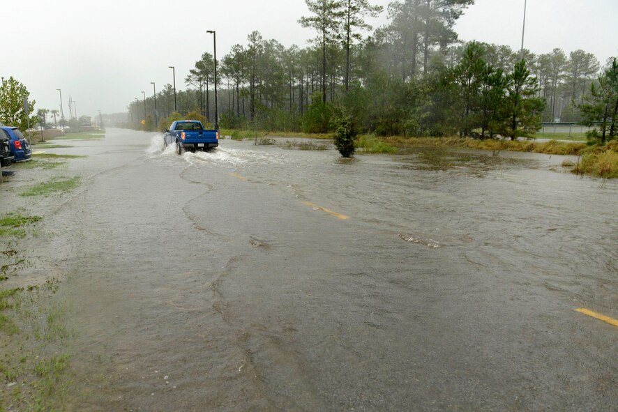 A truck drives through flood waters during the storm that resulted from Hurricane Joaquin at Shaw Air Force Base, S.C., Oct. 4, 2015. The storm caused an unprecedented 19.99 inches of rain, which required emergency responders, security forces, and other mission essential personnel to work through the storm to maintain the base. (U.S. Air Force photo by Airman 1st Class Christopher Maldonado/Released)