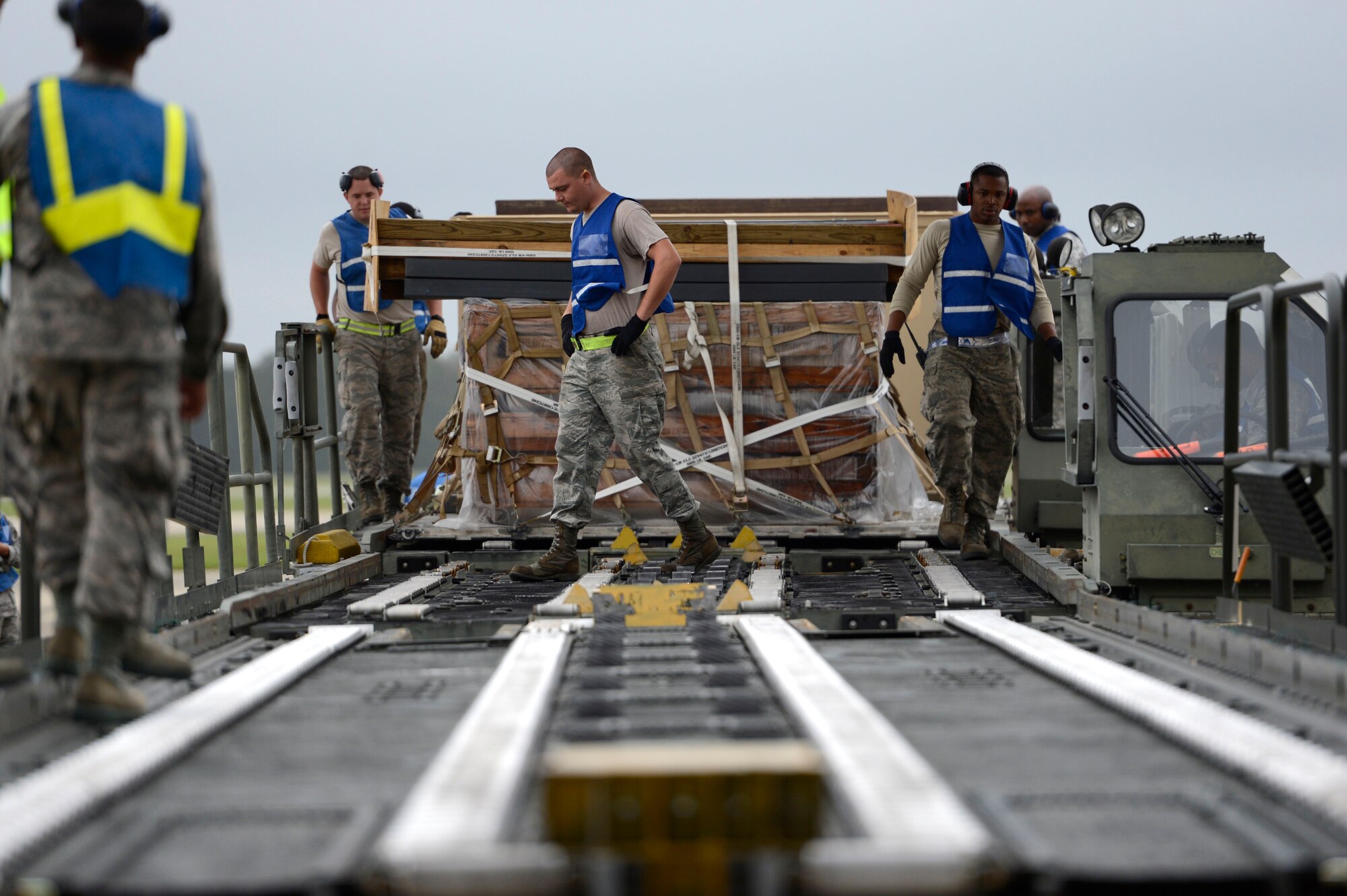 U.S. Air Force Airmen assigned the 20th Logistics Readiness Squadron prepare a 60K-Loader while processing cargo at Shaw Air Force Base, S.C., Oct. 1, 2015. The Airmen were loading cargo onto an aircraft in preparation for an upcoming 55th Fighter Squadron deployment. (U.S. Air Force photo by Senior Airman Jensen Stidham/Released)