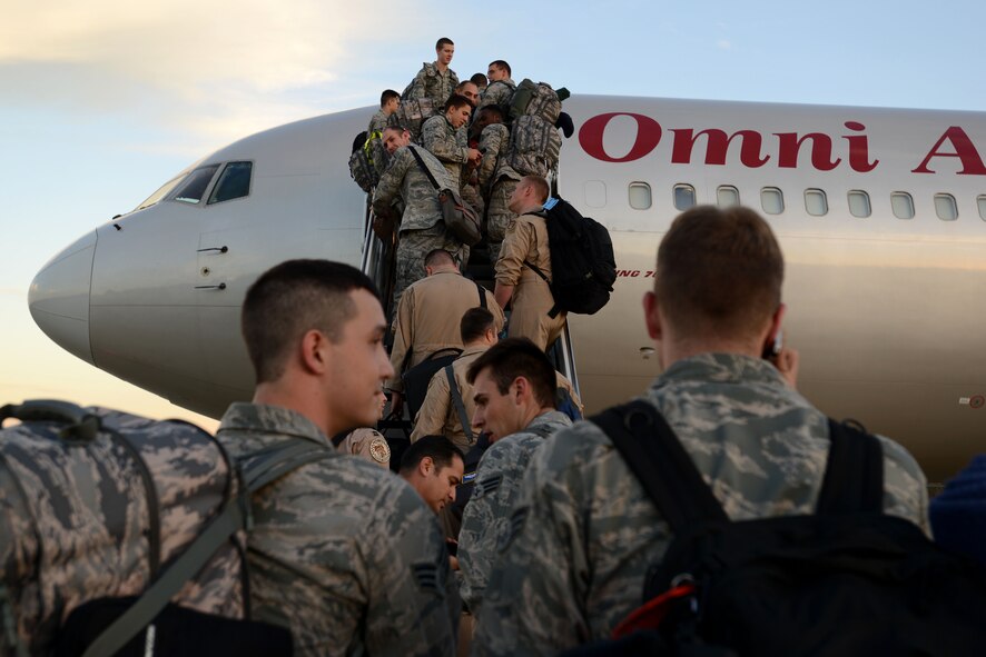 U.S. Air Force Airmen prepare to board a plane at Shaw Air Force Base, S.C., Oct. 6, 2015. The 55th Fighter Squadron departed for a six month deployment to the U.S. Air Forces Central Command area of responsibility. (U.S. Air Force photo by Airman 1st Class Kelsey Tucker/Released)