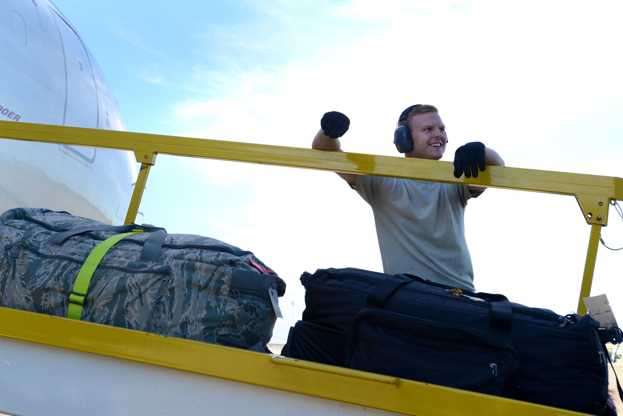 U.S. Air Force Airman 1st Class Caleb Stroud, 20th Logistics Readiness Squadron air transportation apprentice, helps load baggage into the cargo hold of an aircraft at Shaw Air Force Base, S.C., Oct. 6, 2015. The 20th LRS was heavily involved in the logistics of the deployment, from scheduling and planning airlifts, to the loading of the aircraft. (U.S. Air Force photo by Airman 1st Class Kelsey Tucker/Released)