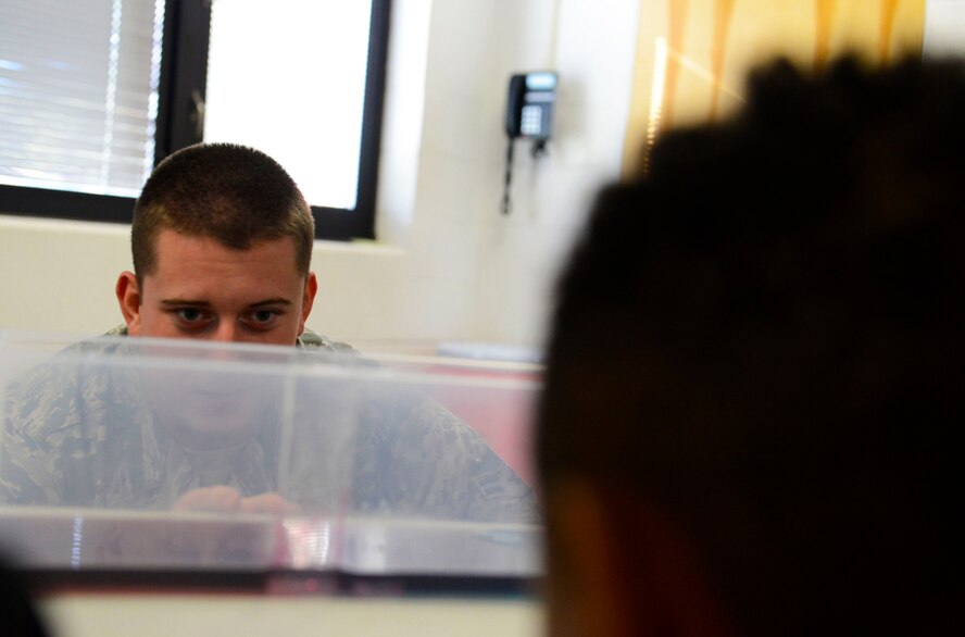 U.S. Air Force Airman 1st Class Zachary Fister, 20th Operation Support Squadron weather trainee, simulates the formation of a cold weather front to middle school students at Alice Drive Middle School, Sumter, S.C., Oct. 15, 2015. Fister used hot and cold water to show what happens when cold air meets hot air. (U.S. Air Force photo by Airman 1st Class Christopher Maldonado/Released)