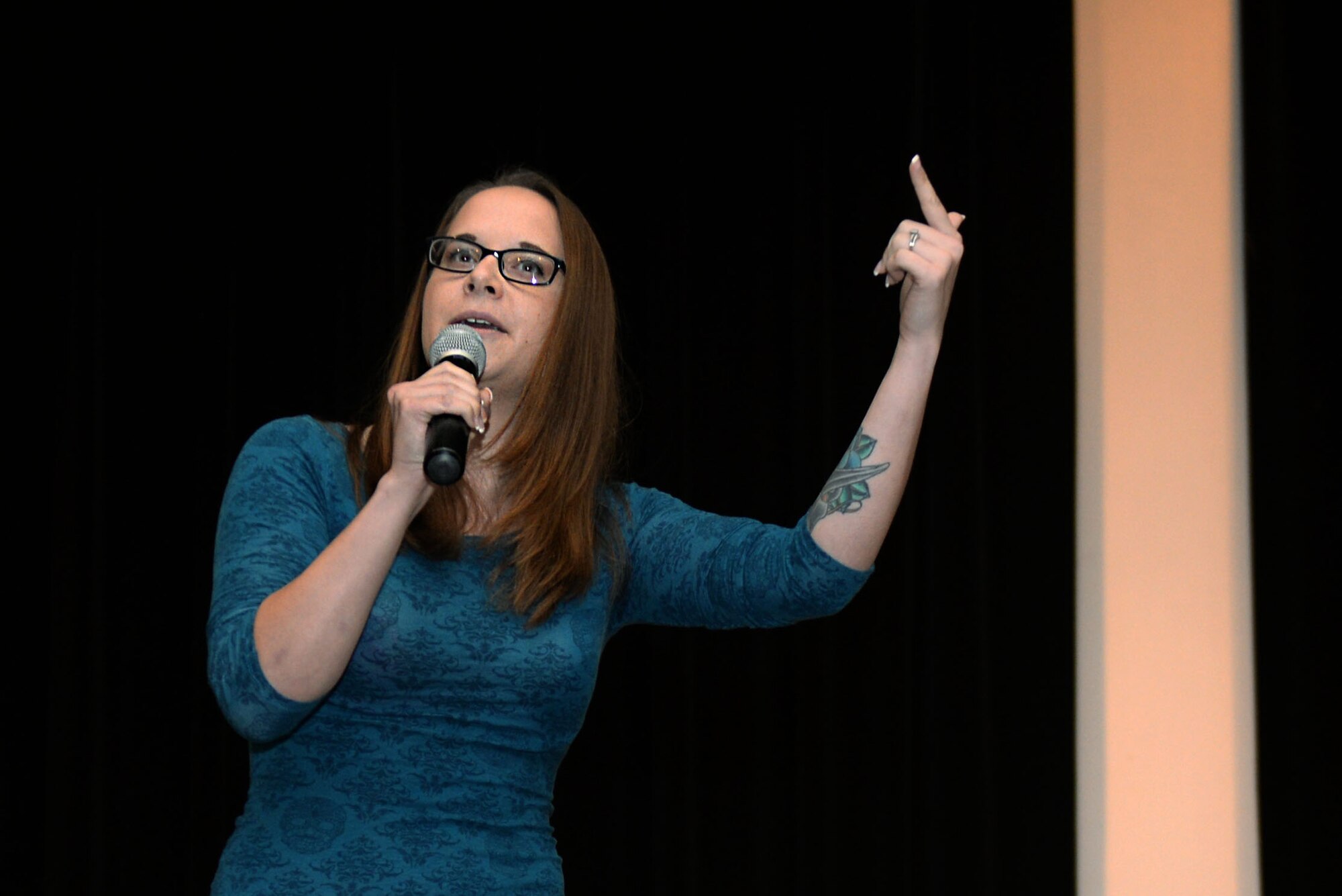 Senior Airman Jennifer Snyder, 4th Force Support Squadron personnelist, recites a poem entitled “Freedom for Some” during the base talent show, Oct. 16, 2015, at Seymour Johnson Air Force Base, North Carolina. In her poem, Snyder depicted the problems with freedom in America. (U.S. Air Force photo/Airman 1st Class Ashley Williamson)