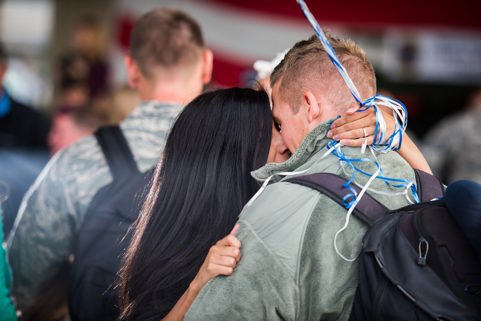 Cara Carnafel (left) embraces her husband, Airman 1st Class Alex Carnafel, 726th Air Control Squadron air surveillance member, for the first time in six months Oct. 18, 2015 at Mountain Home Air Force Base, Idaho. Moments before, Cara said “It’s been so long but it’s all going to be worth it in the next 10 minutes; I just can’t wait to see him.” Alex was deployed to Southwest Asia with the 726th ACS. (U.S. Air Force photo by Airman 1st Class Connor J. Marth)