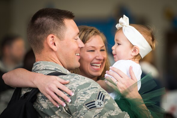 (From the left) Senior Airman Jesse Strength, 726th Air Control Squadron weapons director, Wendi Strength and their daughter, Camden, share a moment Oct. 18, 2015 at Mountain Home Air Force Base, Idaho. Jesse spent six months in Southwest Asia with the 726th ACS supporting various missions throughout the region. (U.S. Air Force photo by Airman 1st Class Connor J. Marth)