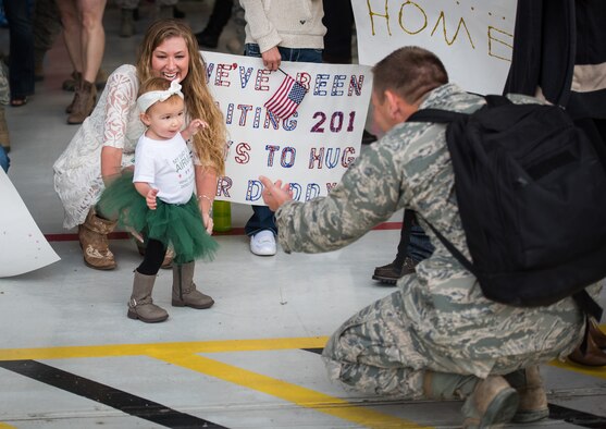 Camden Strength, daughter of Senior Airman Jesse Strength, 726th Air Control Squadron weapons director, walks to her father for the first time Oct 18, 2015 at Mountain Home Air Force Base, Idaho. Jesse missed her first steps while on a six-month deployment to Southwest Asia. (U.S. Air Force photo by Airman 1st Class Connor J. Marth)