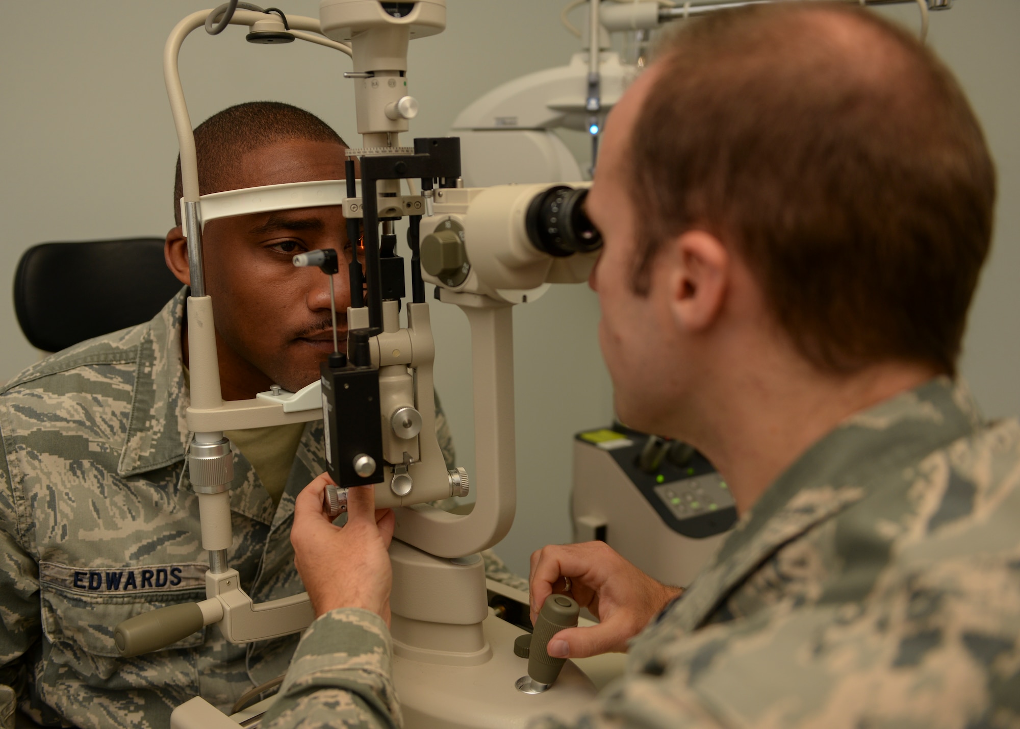 Staff Sgt. Justin Edwards, Shifting Sands Dining Facility assistant manager, receives an eye examination by Capt. Oliver Mullins, an optometrist with the 49th Medical Group, at Holloman Air Force Base, N.M., Oct. 19. “We use this machine to check the overall health of the eyes,” Mullins said. (U.S. Air Force photo by Airman 1st Class Randahl J Jenson/ Released)