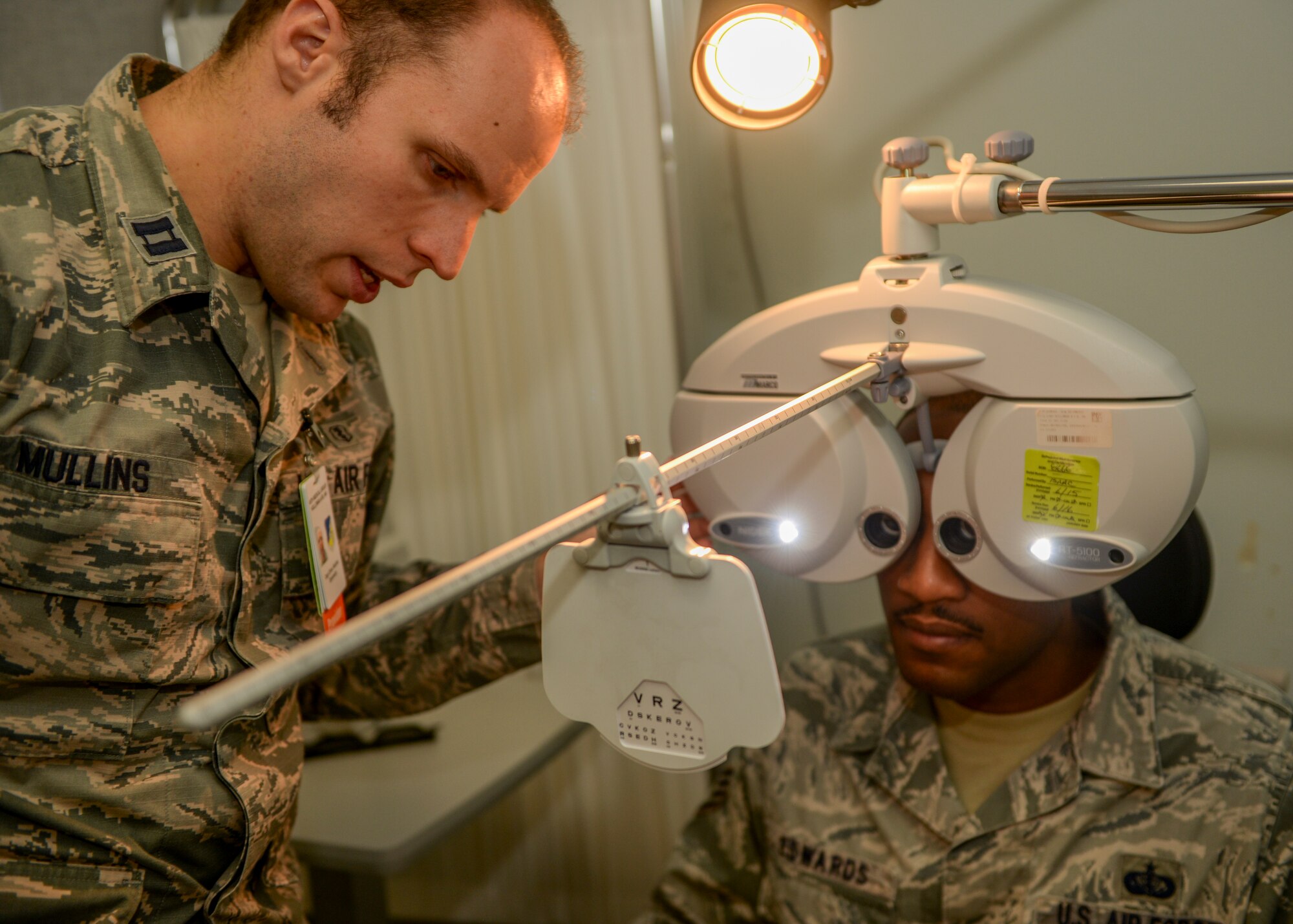 Capt. Oliver Mullins, an optometrist with the 49th Medical Group, determines the prescription needed for his patient, Staff Sgt. Justin Edwards, Shifting Sands Dining Facility assistant manager, at Holloman Air Force Base, N.M., Oct. 19. Optometrists inspect their patients’ eyes for both health and vision problems. If needed, the optometrist will write their patient a prescription for eyewear. “We zero in on what prescription our patient needs and we help them get it,” Mullins said. (U.S. Air Force photo by Airman 1st Class Randahl J Jenson/ Released) 