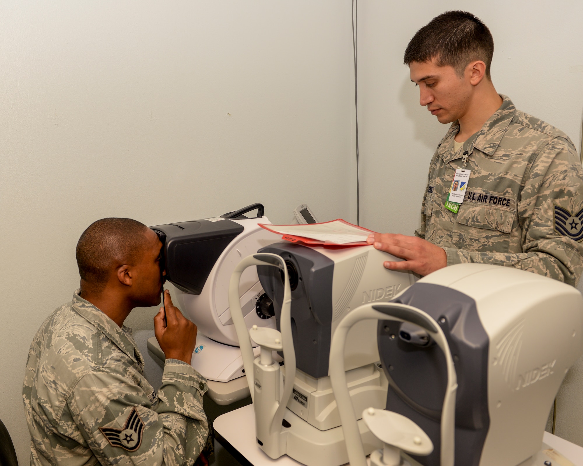 Staff Sgt. Justin Edwards, Shifting Sands Dining Facility assistant manager, focuses during an eye exam as Tech. Sgt. Marvin Gutierrez, an optometry technician with the 49th Medical Group, tests the patient’s vision at Holloman Air Force Base, N.M., Oct. 19. Optometry technicians prepare patients for the optometrists by helping them fill out paperwork, arranging their records and performing pre-examinations. (U.S. Air Force photo by Airman 1st Class Randahl J Jenson/ Released)