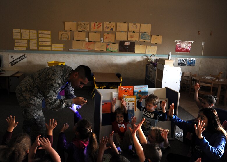 Airman 1st Class George Santiago, 319th Medical Operations Squadron medical technician, tests the hand washing skills of children at the Child Development Center Oct. 20, 2015, on Grand Forks Air Force Base, North Dakota. Santiago used Glo Germ to show the children how important it is to wash their hands properly. The black light exposed how many germs were still present after the children washed their hands. (U.S. Air Force photo by Airman 1st Class Ryan Sparks/Released) 
