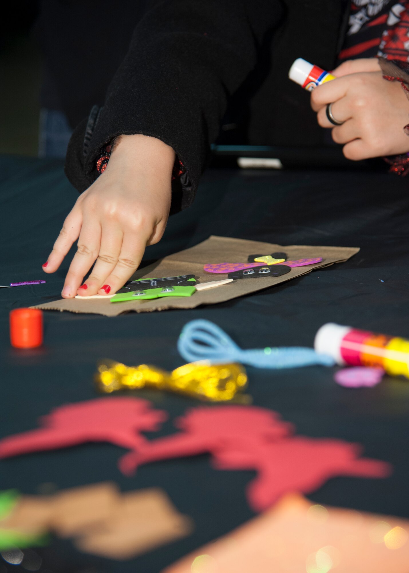 Molly Bond decorates a paper bag Oct. 15, 2015 at the Youth Center on Dover Air Force Base, Del. The bag decorating was a part of the Deployed Families Dinner which is a quarterly event for families of deployed Team Dover members. (U.S. Air Force photo/Staff Sgt. Jared Duhon)