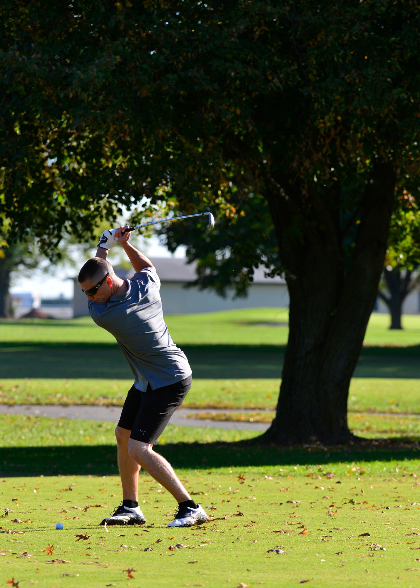 Staff Sgt. James Keener, 373d Training Squadron instructor, swings at a golf ball during the 2015 fall Bluesuiters Golf Tournament Oct. 16, 2015, at Eagle Creek Golf Course on Dover Air Force Base, Del. Keener was one of many Team Dover Airmen who was sponsored by local civic and business leaders to play in the tournament. (U.S. Air Force photo/Senior Airman William Johnson)