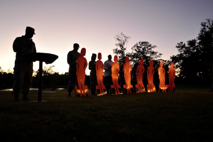 Capt. Sean Kimsey, 628th Medical Group officer, reads stories of fallen Airmen during the Domestic Violence candlelight vigil ceremony at Joint Base Charleston, S.C., Oct. 19, 2015. The ceremony honored all of those who have been affected by domestic violence, both living and deceased, by sharing stories, lighting candles and releasing balloons. (U.S. Air Force photo/Tech. Sgt. Renae Pittman)