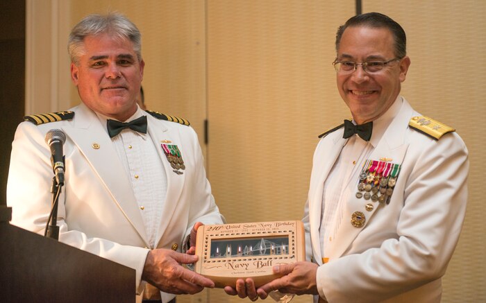 Captain Timothy Sparks presents a gift to Rear Admiral David Steindl, Navy Personnel Command deputy chief, celebrating the Navy’s 240th birthday at the Navy Ball on Oct. 17, 2015, at the Charleston Marriott Hotel. Steindl was the guest speaker at the Navy Ball.