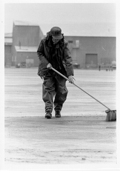 A 92nd avionics maintenance Airman sweeps ash from the Mt. St. Helens eruption off the flight line, May 18, 1980, at Fairchild Air Force Base, Wash. (U.S. Air Force photo by Airman 1st Class David McLeod)