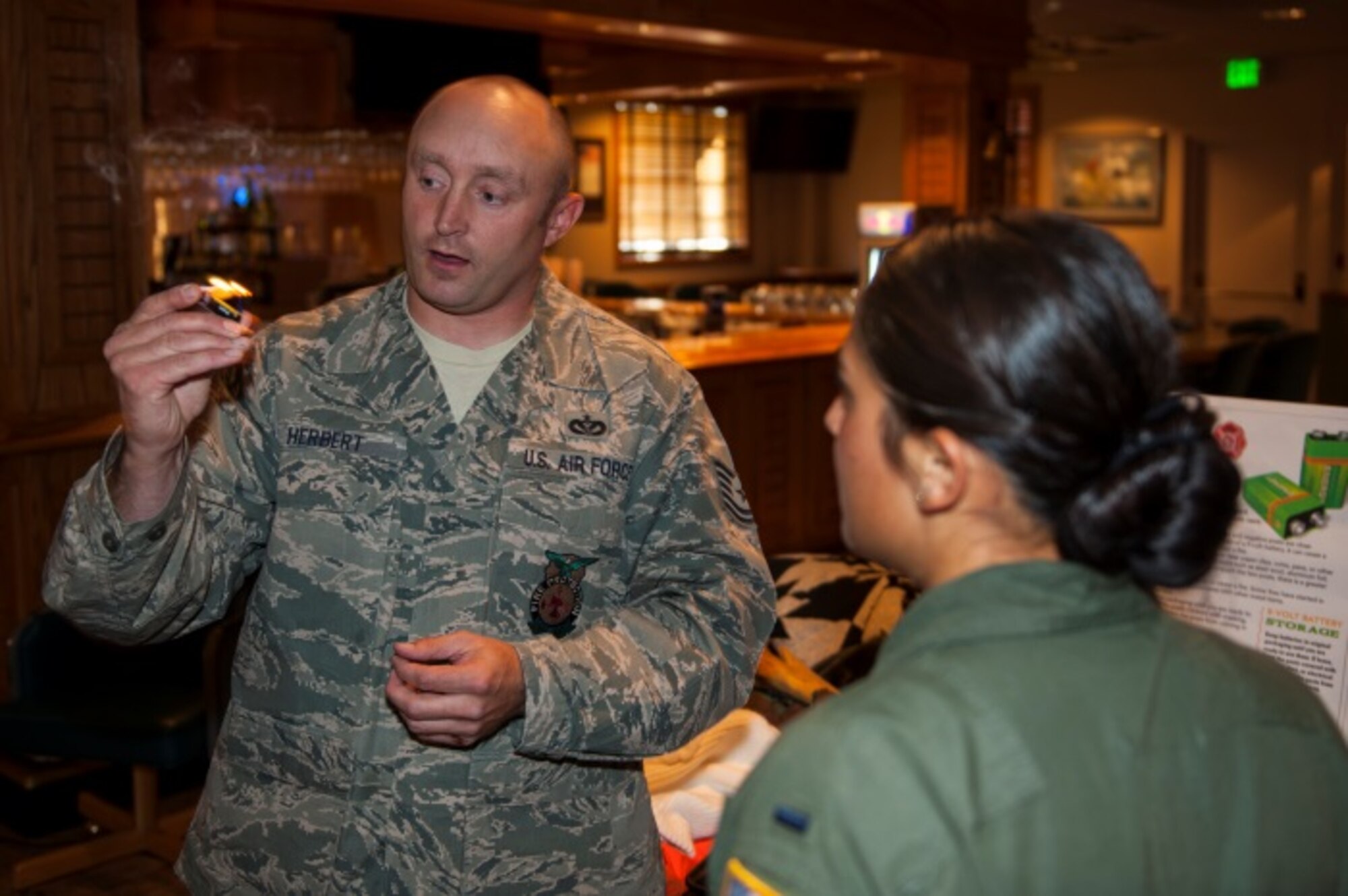 Tech. Sgt. Scott Herbert, 5th Civil Engineer Squadron assistant chief of health and safety, shows an exhibit on fire safety at Minot Air Force Base, N.D., Oct. 14, 2015. Minot held a winter safety expo to help educate Minot personnel for the upcoming winter. (U.S. Air Force photo/Airman 1st Class Christian Sullivan)
